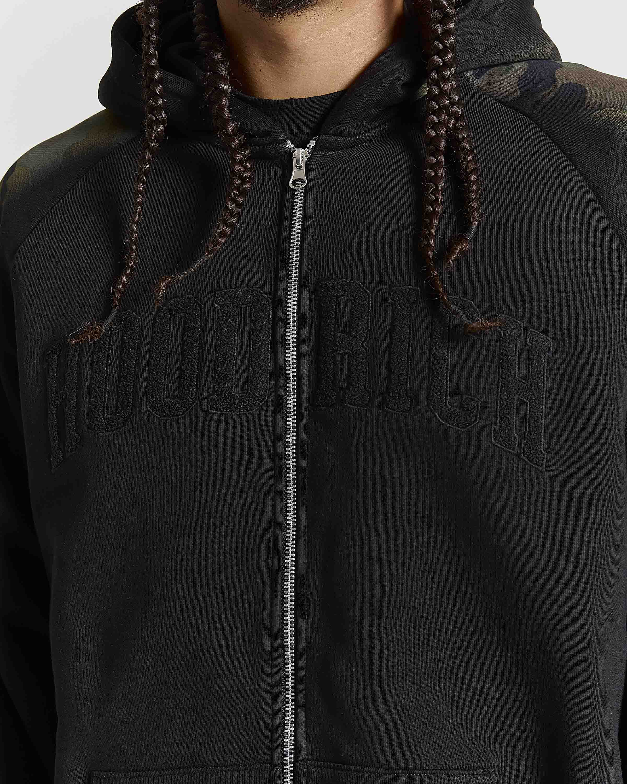 Displays a model wearing the Black Camo 'Hoodrich' branded men's Shade Matching Shorts Set