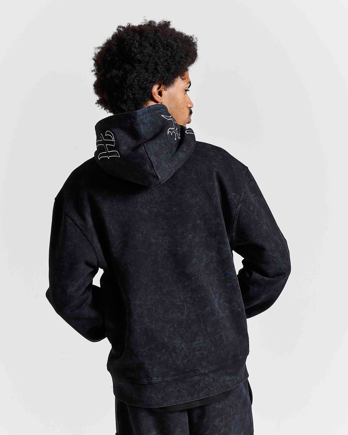 Displays a model wearing the Black 'Hoodrich' branded men's Nocturn Full Tracksuit