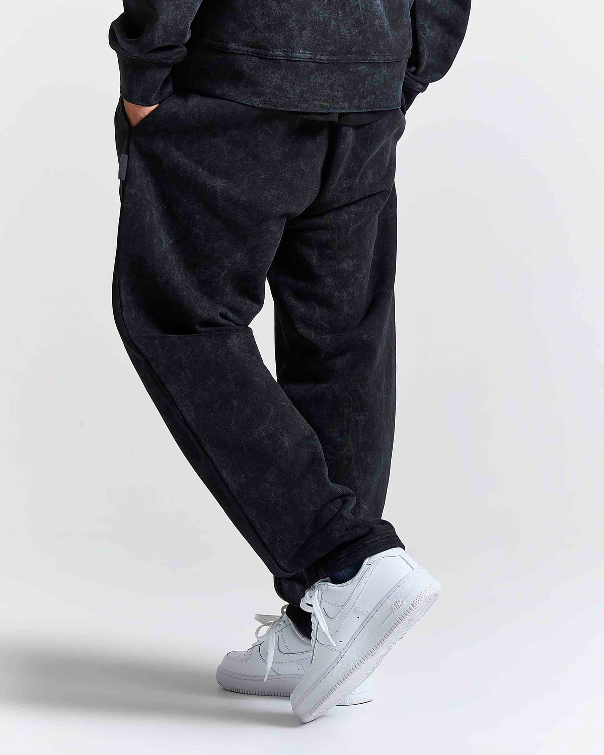 Displays a model wearing the Black 'Hoodrich' branded men's Nocturn Full Tracksuit