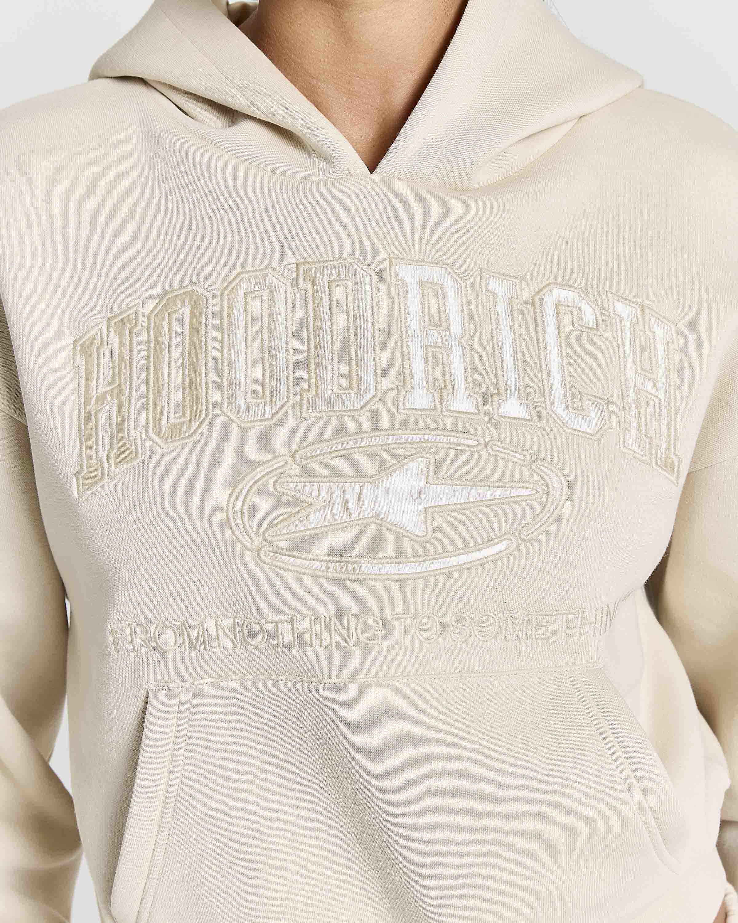 Displays a model wearing the Stone 'Hoodrich' branded women's Aegis Full Tracksuit
