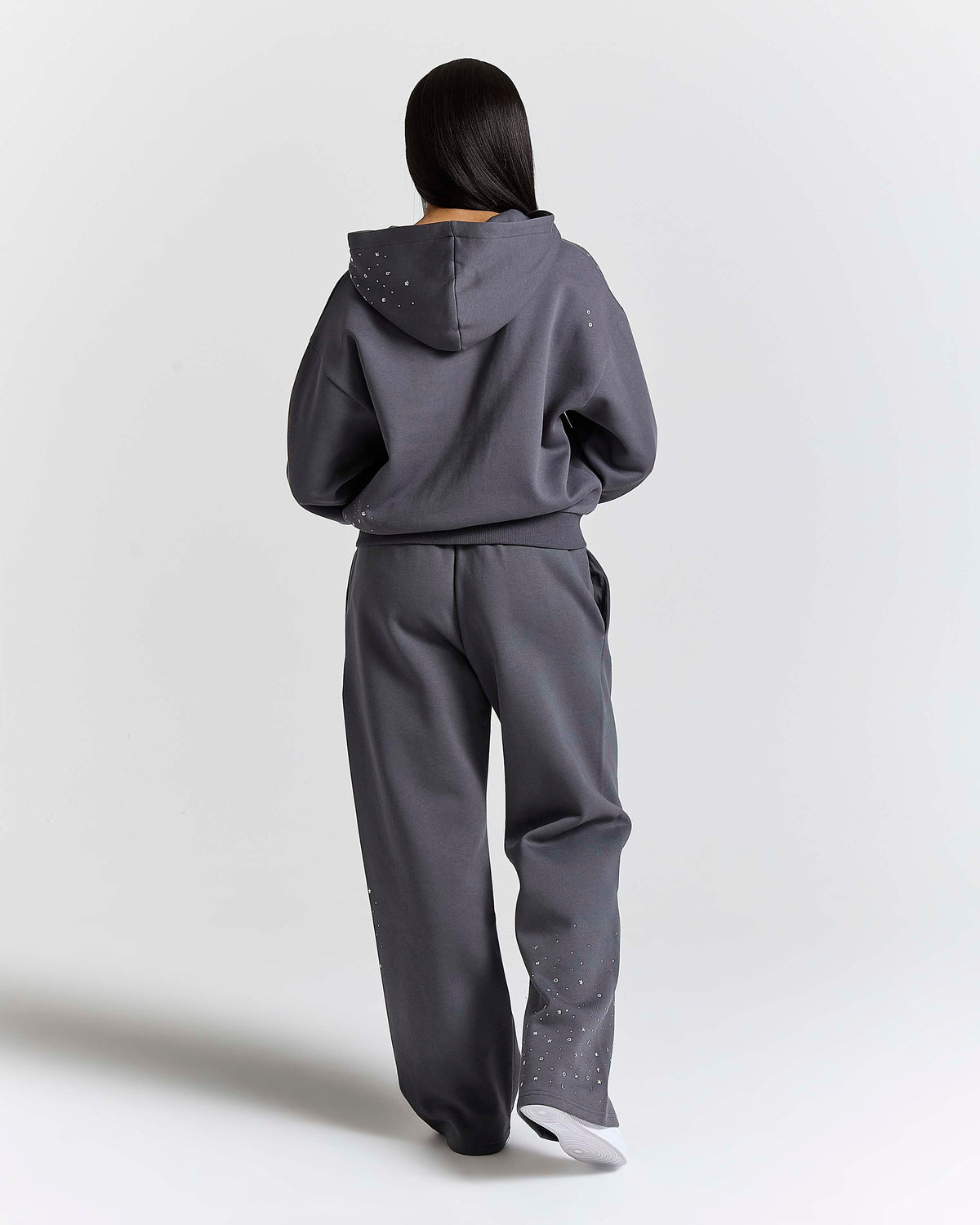 Displays a model wearing the Silver rhinestone 'Hoodrich' branded Clash V2 Mid Length Z/T Hoodie
