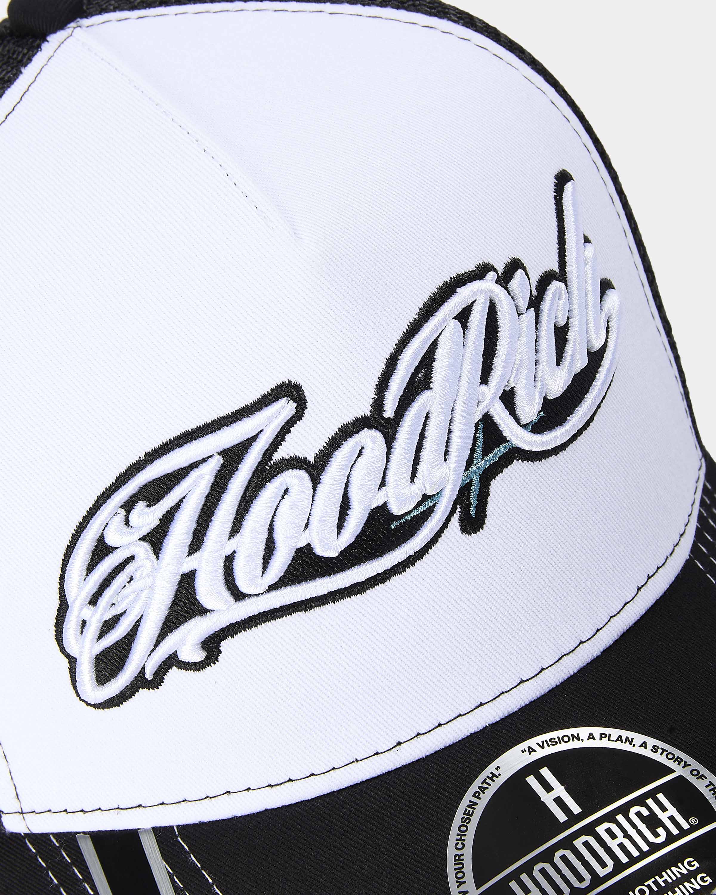 Close-up of a cap with 'Hoodrich' branding on a white background
