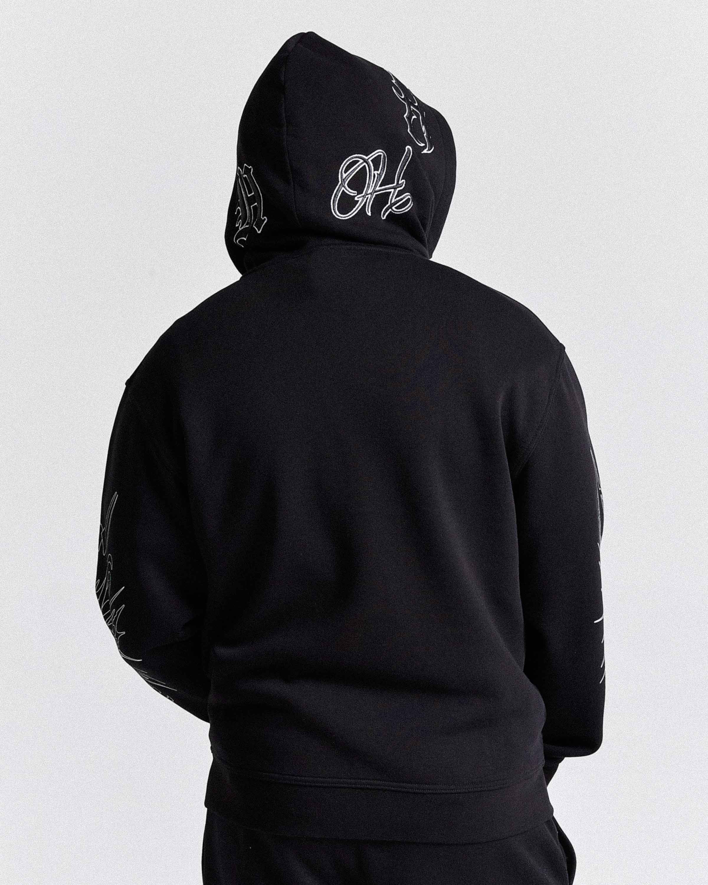 Black hoodie with white text on the back against a light gray background