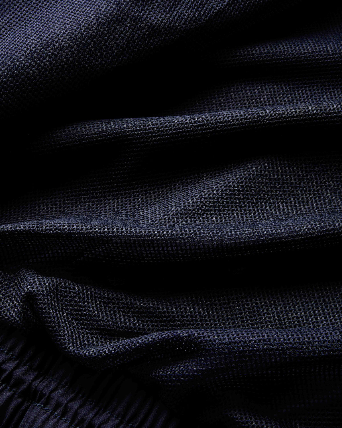 Close-up of dark blue fabric with a textured pattern
