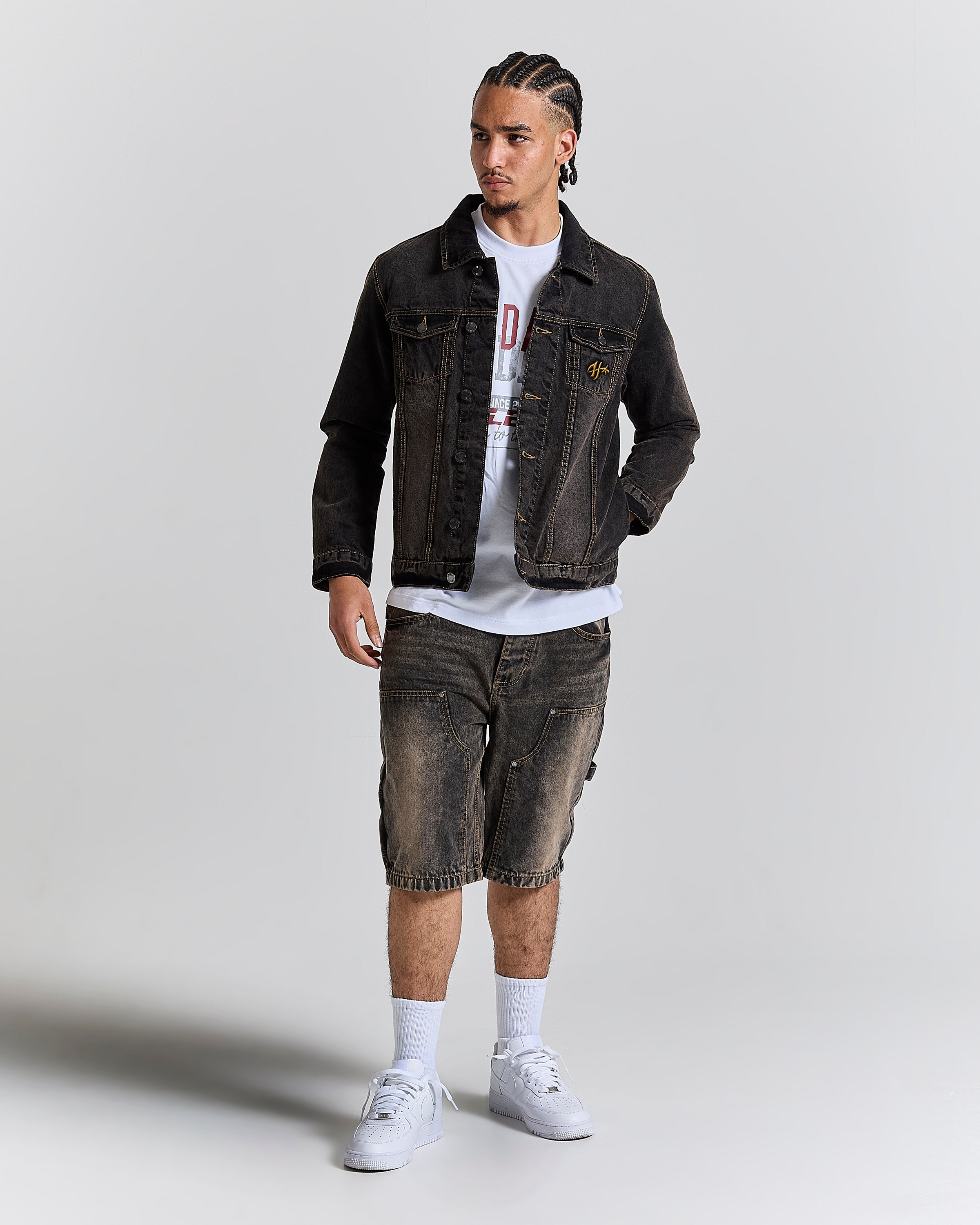 Model wearing a regular fit black rust washed denim jacket and matching jeans.