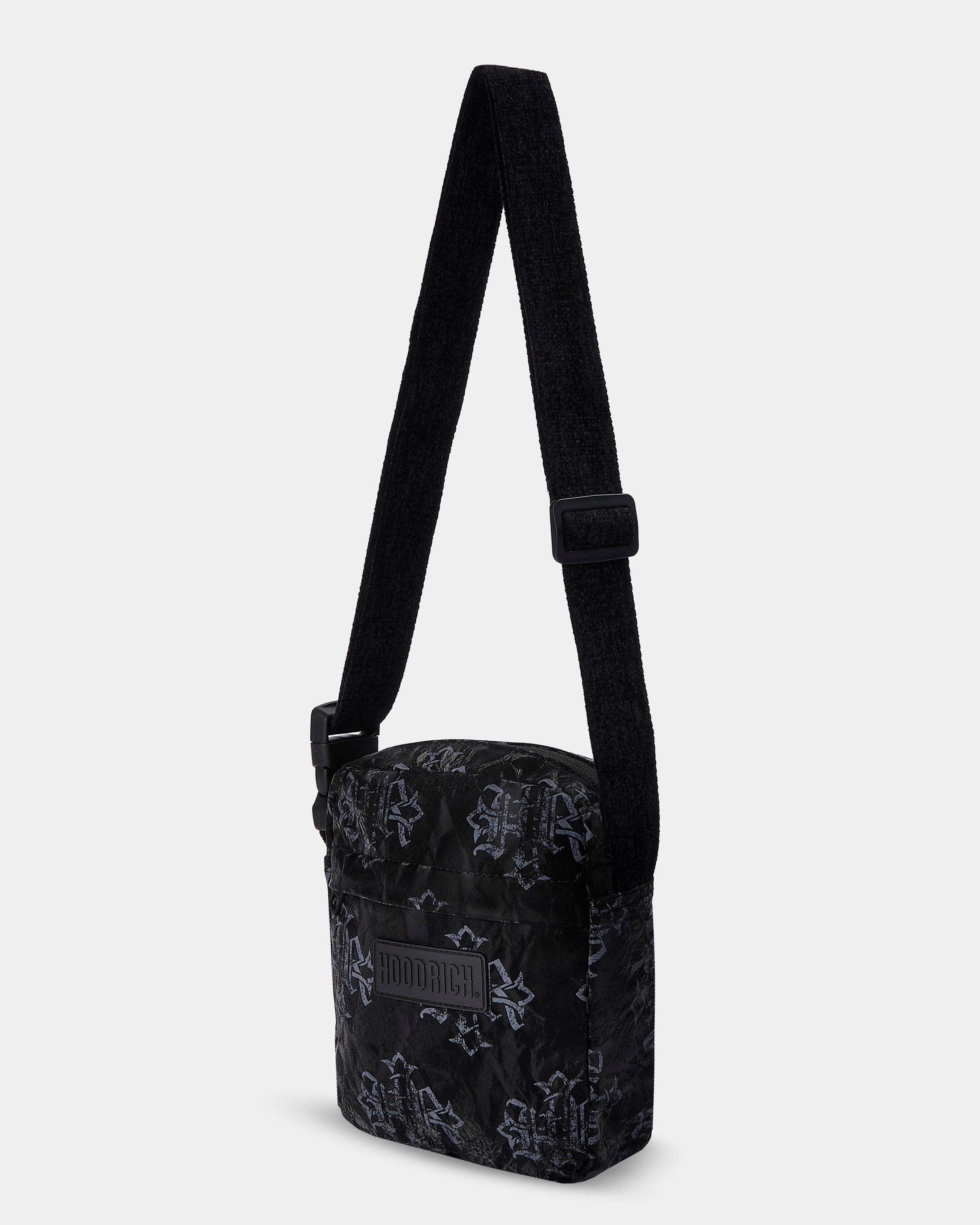 Black crossbody bag with subtle pattern on a white background