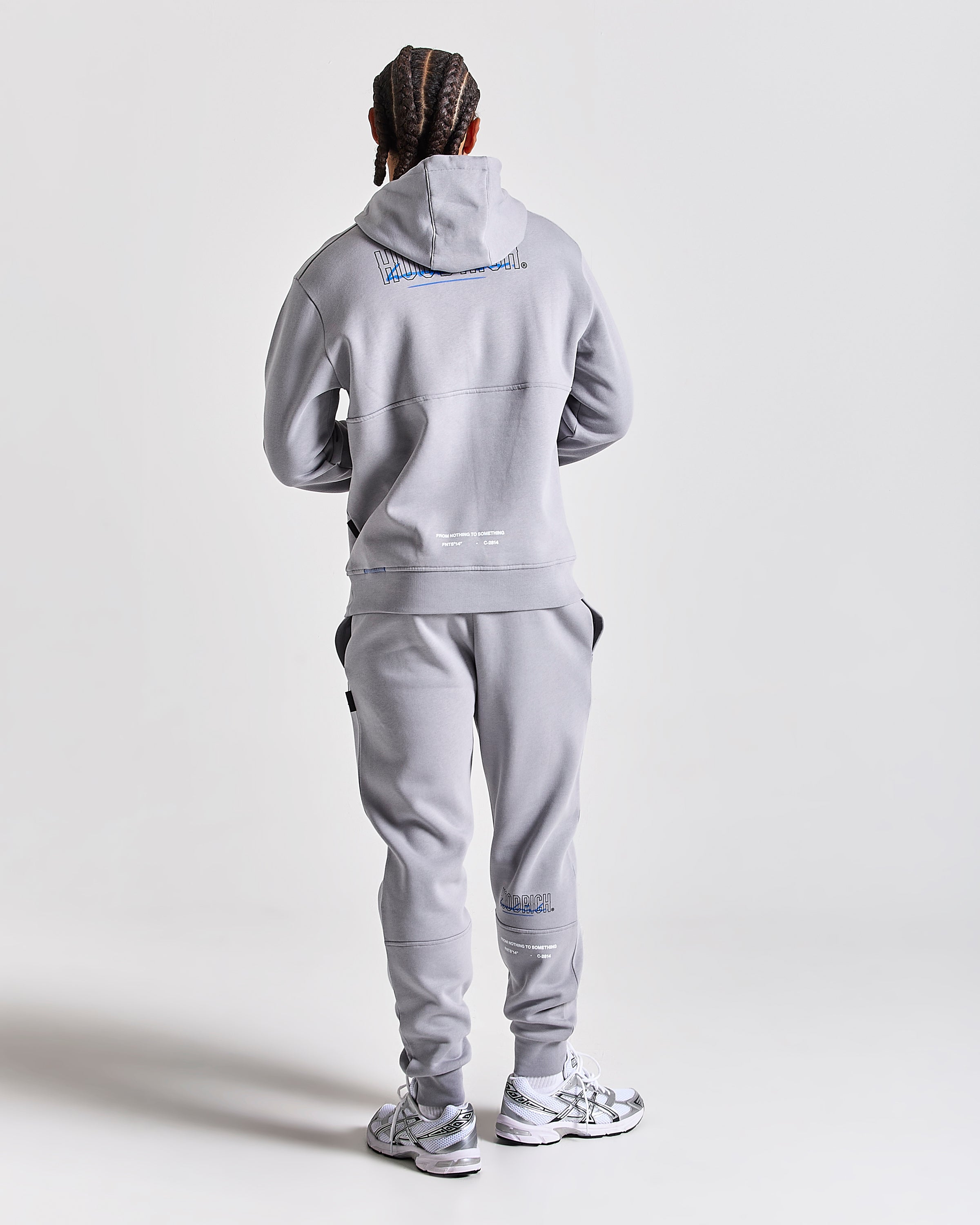 Displays a model wearing the Grey 'Hoodrich' branded men's blend Full Tracksuit 
