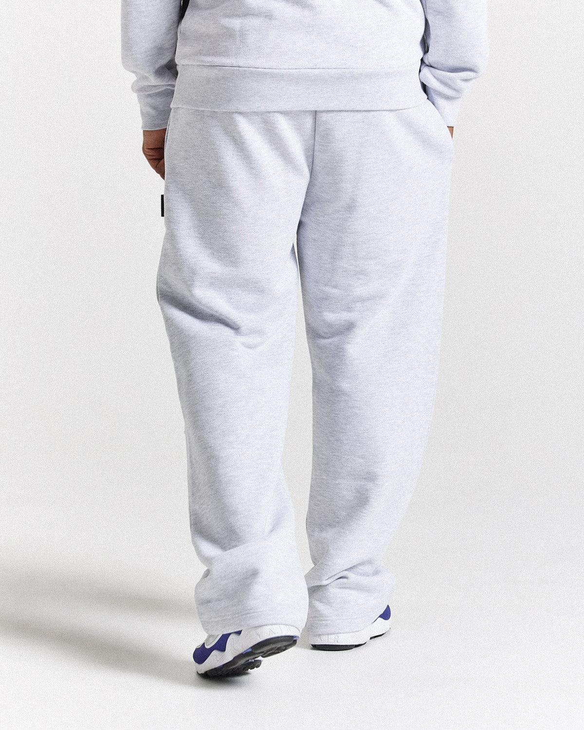 Displays a model wearing the light grey 'Hoodrich' branded men's Asthrich Full Tracksuit 