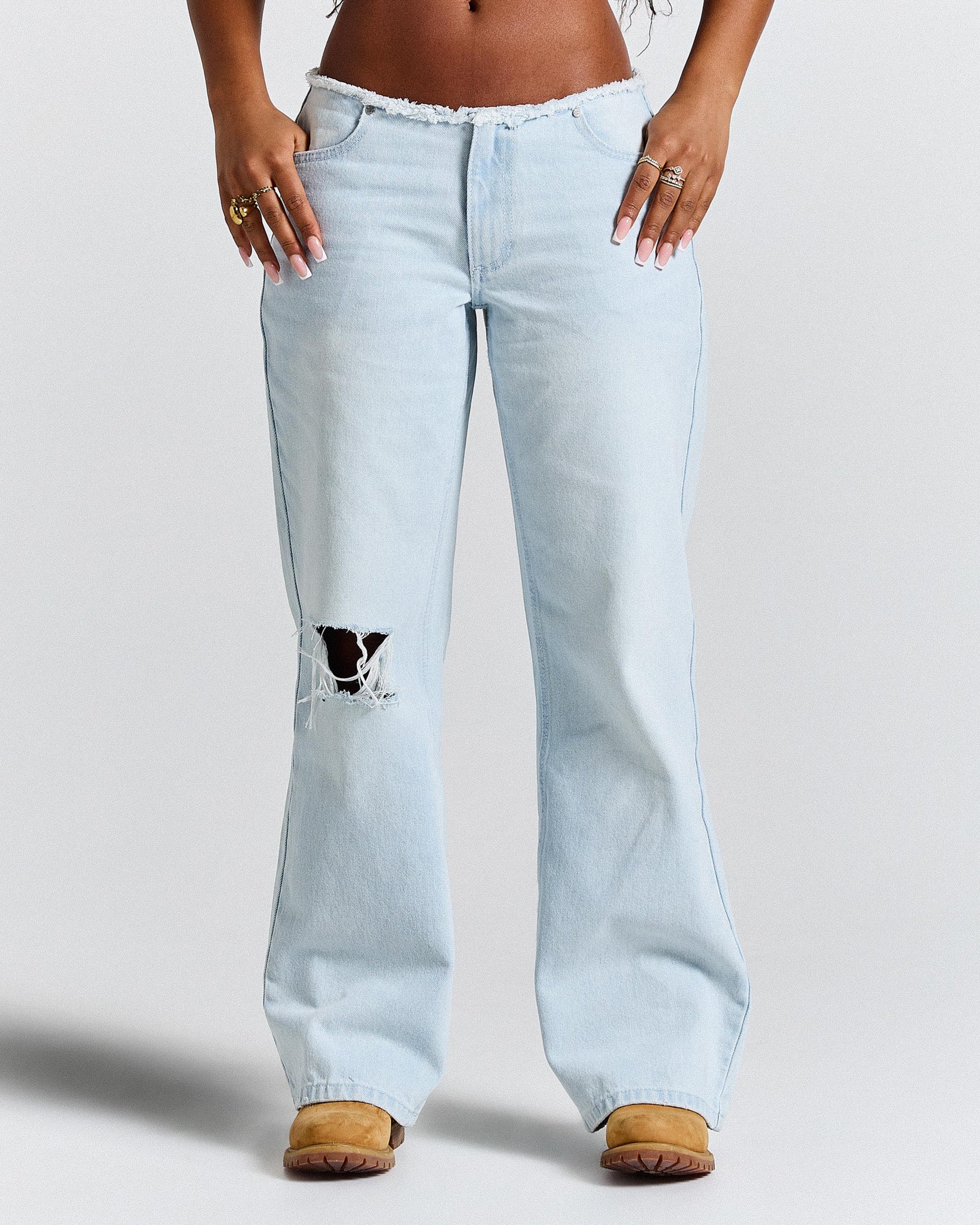 Light blue jeans with a small design on a plain background
