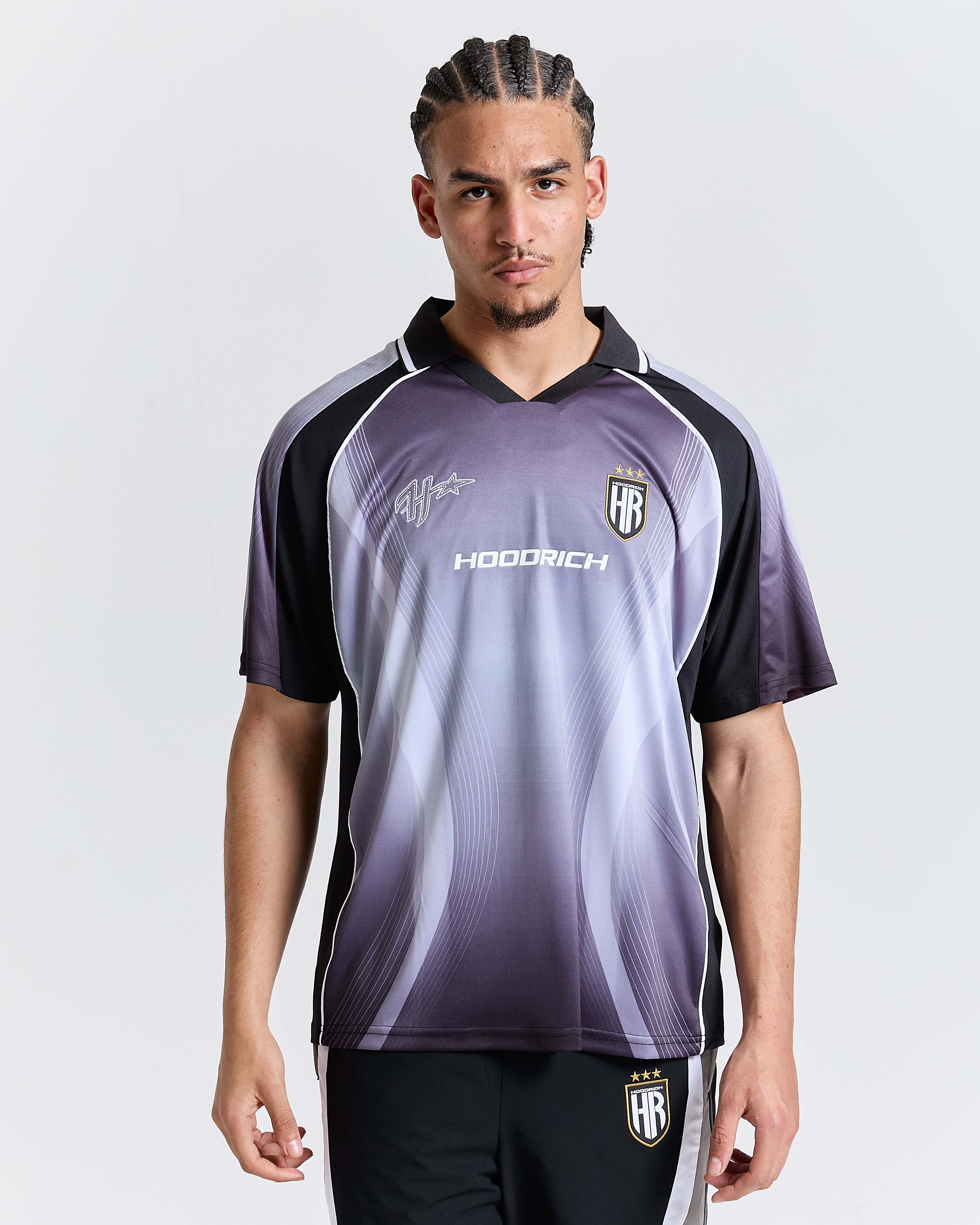Person wearing a purple and black sports jersey with 'Hoodrich' branding on a white background