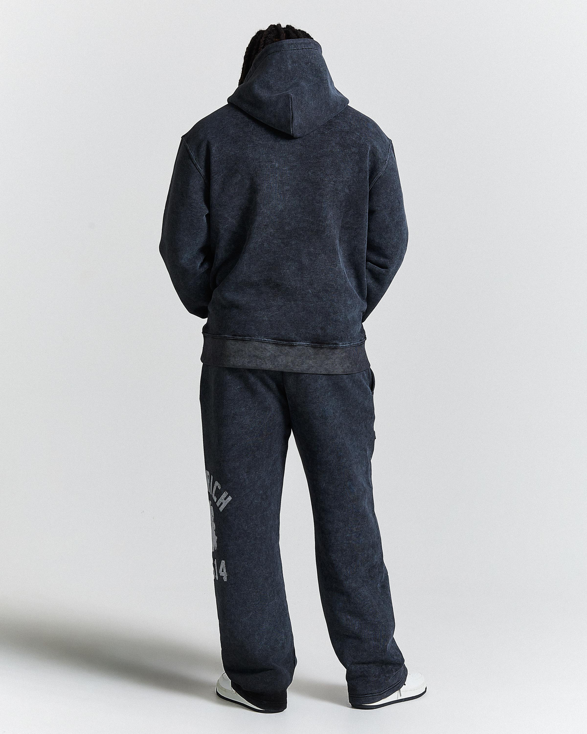 Displays a model wearing the Black Wash 'Hoodrich' men's The Winner's Cipher Full Tracksuit 