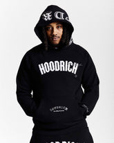 Person wearing a black 'Hoodrich' hoodie with branding on a white background