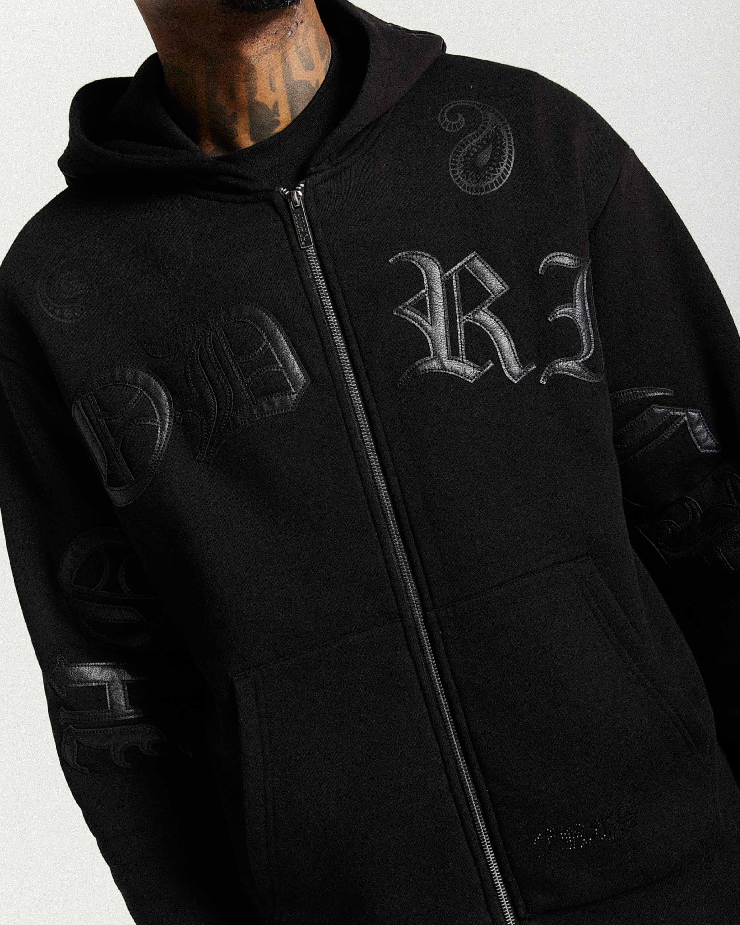 Black hoodie with branding on a white background