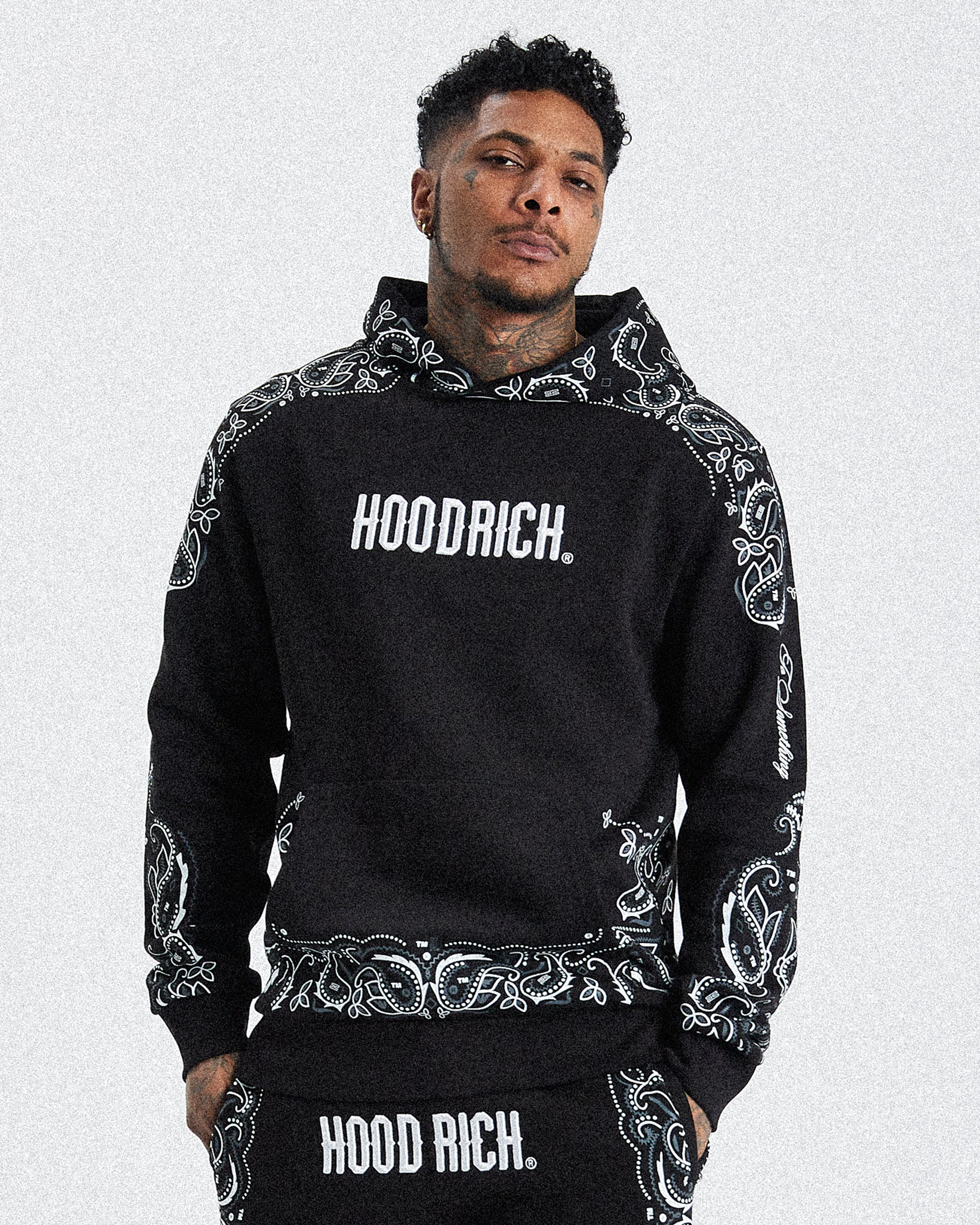 Displays a model wearing the black 'hoodrich' branded men's Motif Full Tracksuit 